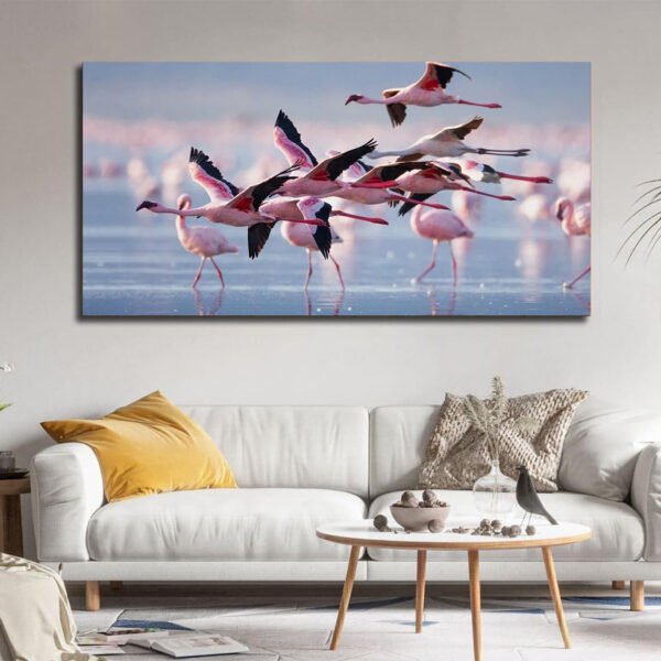 flock of flamingos in flight over water Canvas