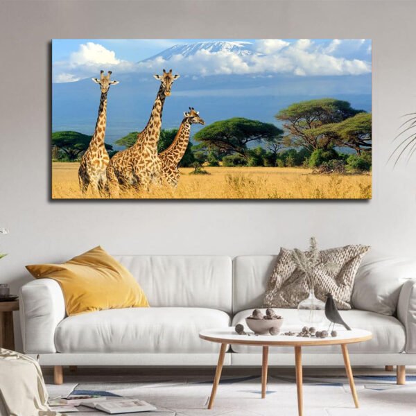Three giraffes in the African savanna with Mount Kilimanjaro Canvas
